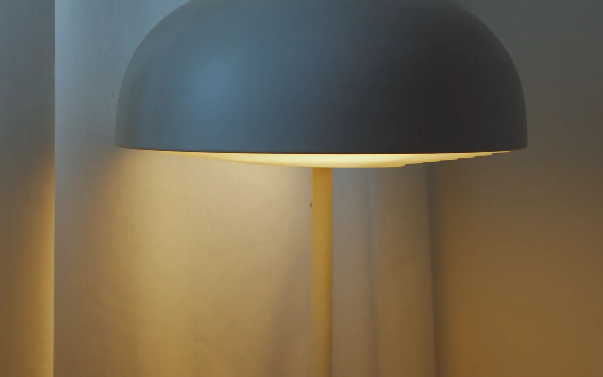 An illuminated table lamp on a side table.